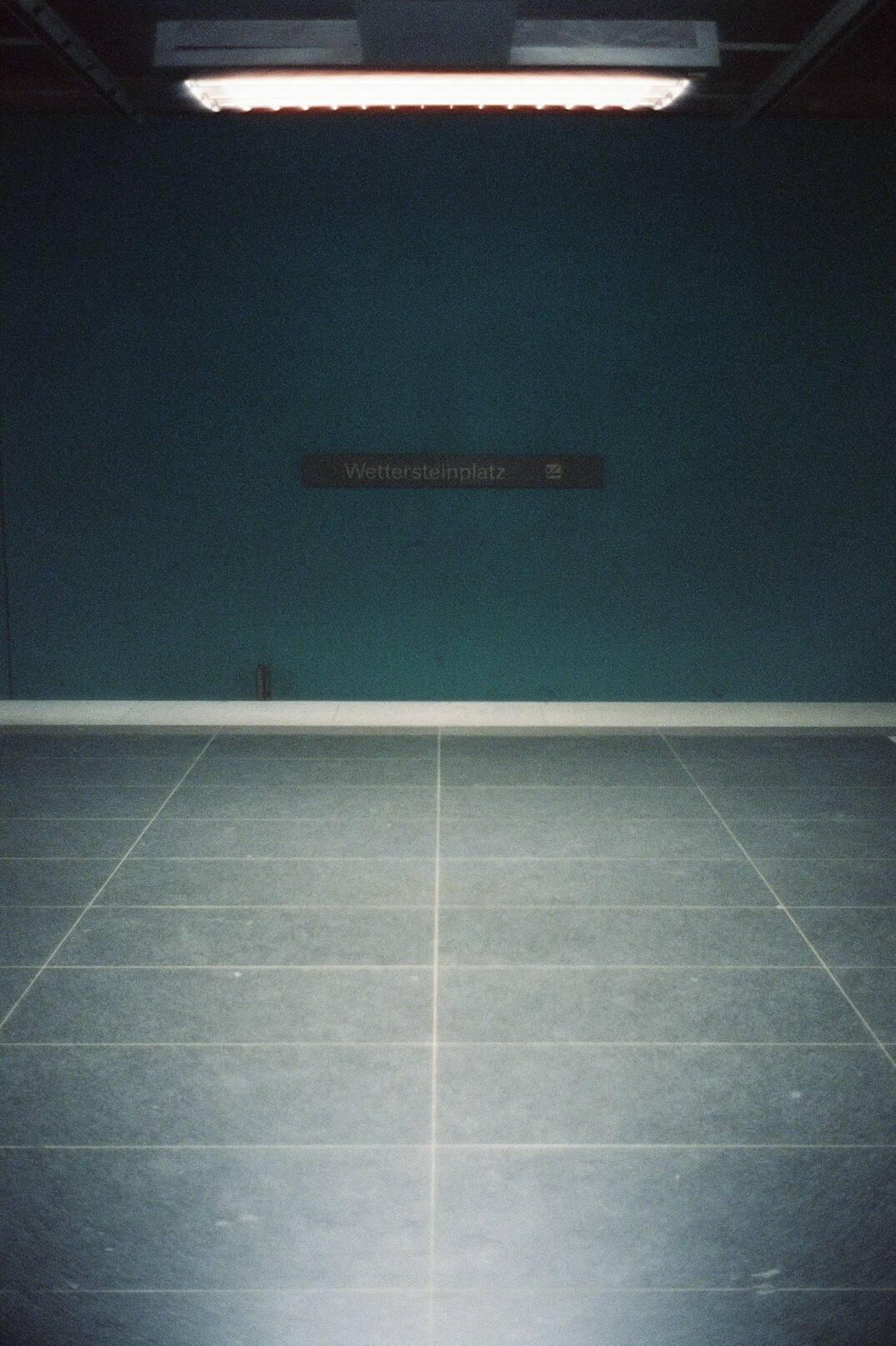 Empty television studio floor with lighting grid overhead and cameras ready